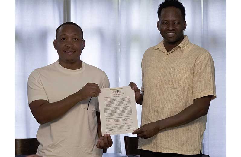 Businessman, Enzo Matthews and SASOD Managing Director, Joel Simpson, holding the LGBTQIA+ Manifesto 2025 (Japheth Savory photo) 
