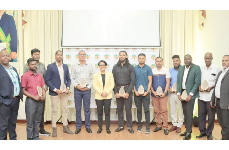 Susan Rodrigues, Minister of Tourism, Industry and Commerce (centre); Roger Rogers, Permanent Secretary, Ministry Tourism, Industry and Commerce (far left); and Mohamed Shazim Ibrahim, Chief Executive Officer of the Small Business Bureau (far right), with awardees of the 2025 Green Technology Fund (SBB photo)