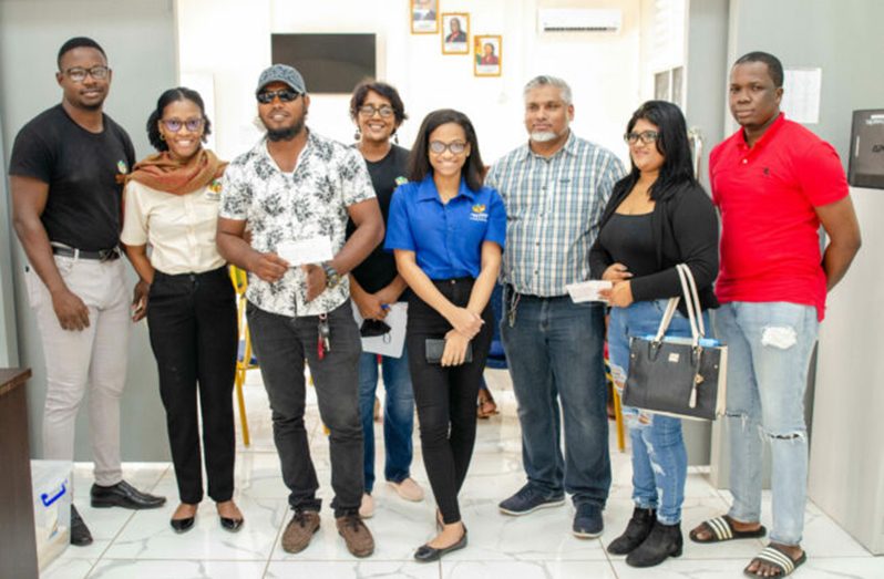 Chief Executive Officer of the Small Business Bureau (SBB), Mohamed Ibrahim, poses with some of the beneficiaries (DPI photo)