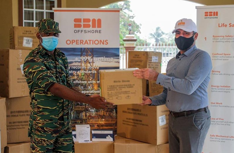 Country Manager of SBM Offshore, Herve Laurioux hands over supplies to Director General of the CDC, Lieutenant Colonel Kester Craig, at the company’s Prashad Nagar, Georgetown office