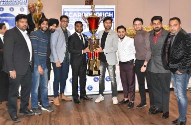 SCA President Shiv Persaud hands over the Elite Division championship trophy to Toronto Rhinos skipper Mohammad Amir Khan in the presence of his teammates.