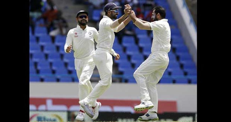 Mohammed Shami celebrates the wicket of Marlon Samuels. He went on to finish with  four for 66.