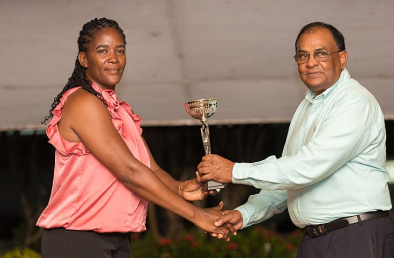 Shelly Daly-Ramdyhan (L) receives her Coach-of-the-Year trophy from GLTA president Samuel Barakat.