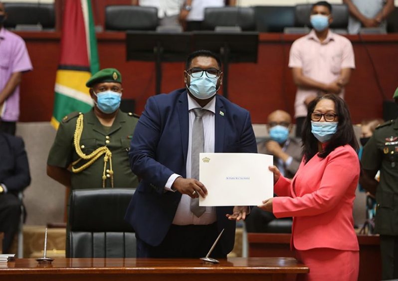 Minister of Amerindian Affairs, the Hon. Pauline Campbell-Sukhai, receives her Instrument of Office from HE President Dr. Mohammed Irfaan Ali (DPI photo)