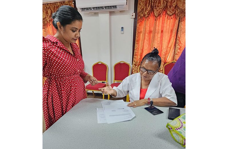 Regional Executive Officer Susannah Saywack witnesses St Monica Toshao Even Samuels signing the contract