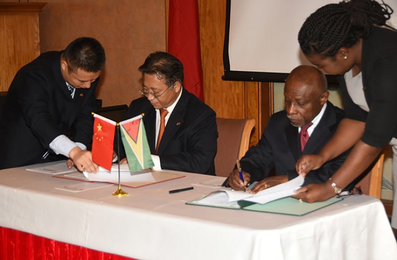 Minister of Foreign Affairs, Carl Greenidge and the Chinese Ambassador to Guyana, Cui Jianchun signing the ‘Silk Road MoU) on cooperation within the Framework of the Silk Road Economic Belt and the 21st Century Maritime Silk Road  Initiative (Photo by Adrian Narine)