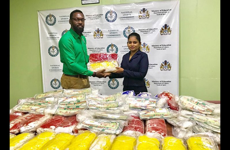 Director of Sport, Christopher Jones, accepts the donation from Silvie’s Sales Manager Naressa Nabby.