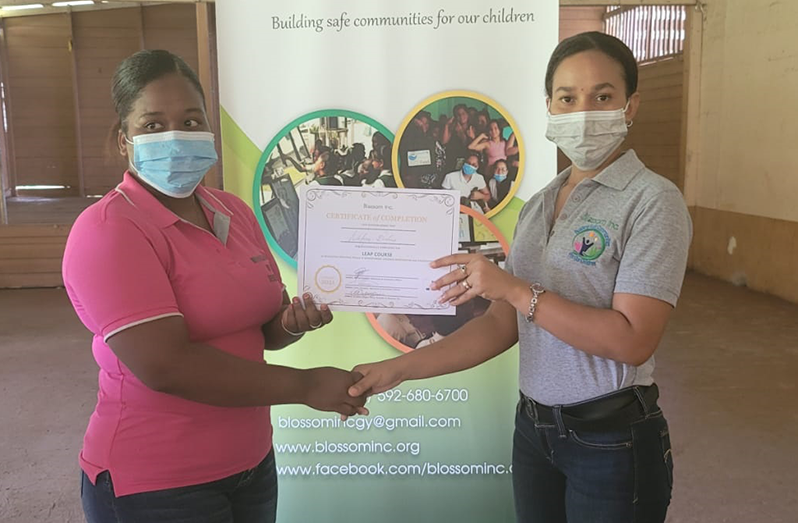 Arlyne Ramdatt, an Education Awareness Officer at Blossom Inc. along with one of the residents of Matthew’s Ridge, who completed the four-day outreach