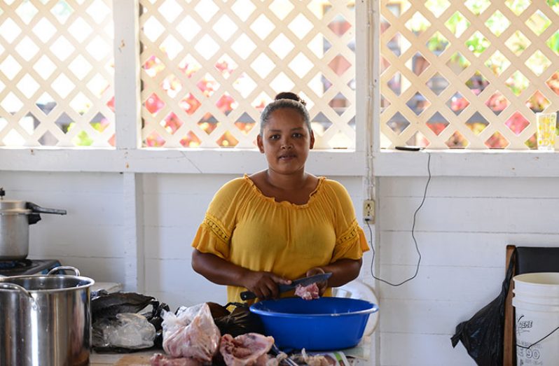 Aranda Somra in the Community Centre preparing some chicken for a portion of cook-up-rice she was cooking during a visit to River’s View (Samuel Maughn photos)