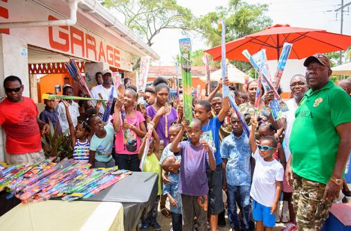 SMP_2627 Owner of ‘The Garage’, Mr Estwick Northe (left) shares a moment with the boisterous children on Sunday