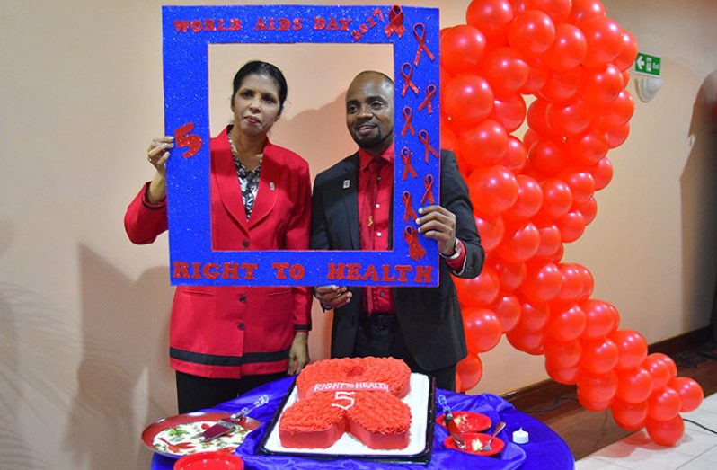 CARICOM Deputy Secretary-General Dr. Manorma Soeknandan and PANCAP’s Mr Vivian Rookhum pose for a quick photo-op in observance of World AIDS Day 2017