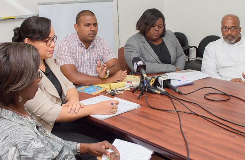Amar Panday , CEO of the Rights of the Child Commission (RCC) speaks to the media during the briefing . Managing-attorney of the Guyana Legal Aid Clinic, Attorney –at-law , Shellon Boyce, is second from right while Andre Gonsalves of the RCC is at right.