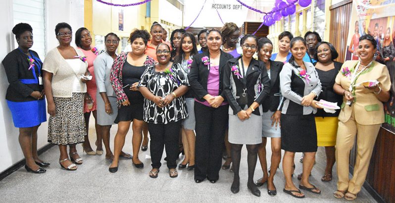 The men of the Guyana Chronicle on Thursday treated the ladies with cake, wine and a rose each in observance of International Women’s Day. In this Samuel
Maughn photo, the ladies led by General Manager Moshamie Ramotar,second left front row, pose for a photo moment