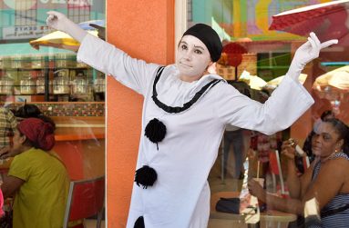 Miljana shows off a few tricks during her miming performance as an inquisitive Guyanese crowd gather to contribute to her cause.