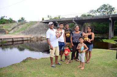 A family posing in front of the Bamia Creek