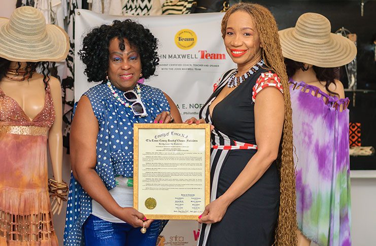 Fashion Designer, Sonia Noel accepts award from the Essex County Board of Chosen Freeholders (from left)  Legislative Aide for Essex County , Ira Lewis and Fashion Designer, Author, Dr. Sonia Noel  (Photo by Delano Williams)