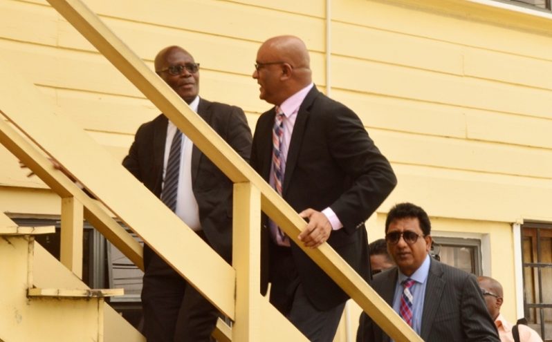 SOCU head, Sydney James climbs the stairs at the unit's headquarters alongside Opposition Leader, Bharrat Jagdeo on Monday. Opposition MP, Anil Nandalall who appeared as Jagdeo's attorney is at right. (Adrian Narine photo)