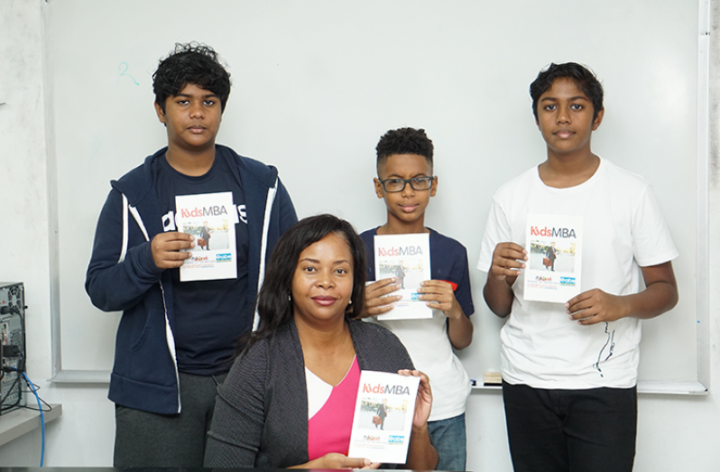 Principal of School of the Nations Primary division, Mischka White, along with some of the students currently enrolled in the programme. – Elvin Croker Photo.