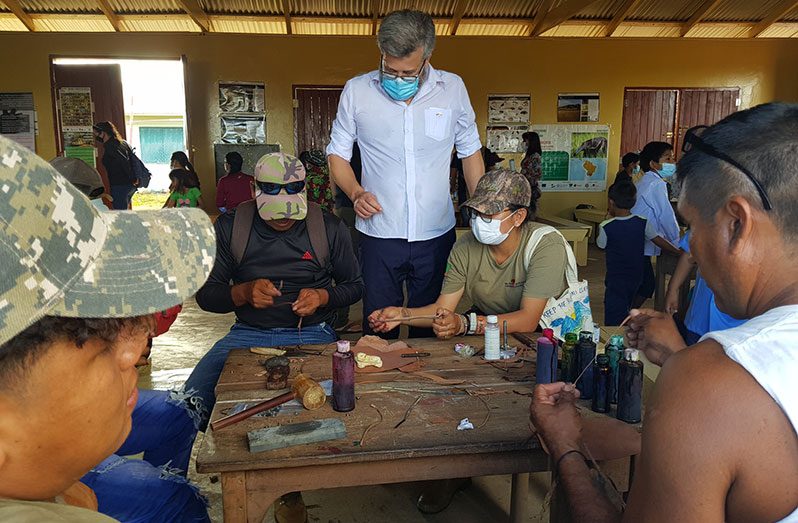 EU Ambassador to Guyana, Fernando Ponz Cantó, watching the creation of the leather crafts (Photos sourced from SRCS)