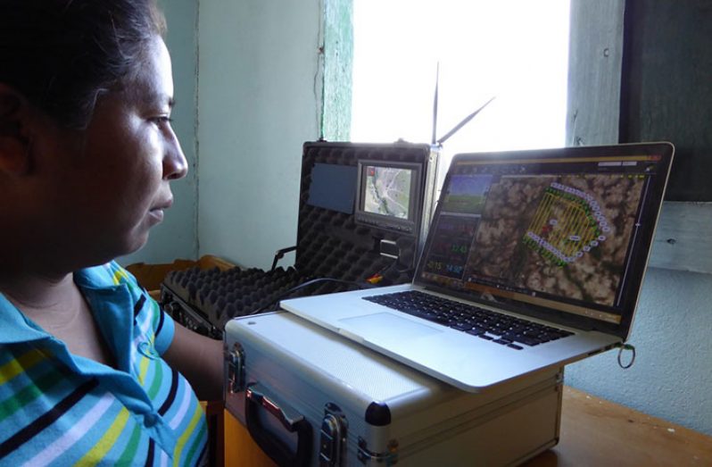 SRDC technician, Tessa Felix, monitors a drone flight over the South Rupununi. (SRDC photo)