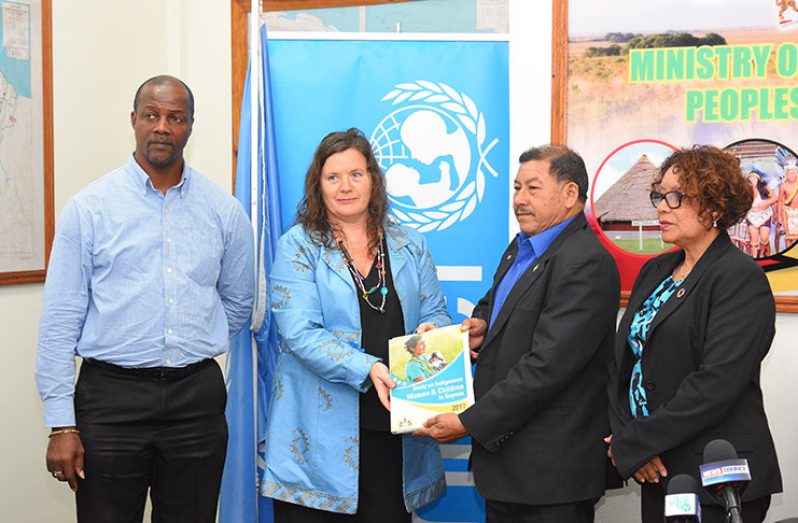 Representative of UNICEF Guyana and Suriname, Sylvie Fouet (second left) hands over the study to the Minister of Indigenous Peoples’ Affairs, Sydney Allicock (second right) in the presence of Junior Minister of Indigenous Peoples’ Affairs Valerie Garrido-Lowe (first right) and Permanent Secretary of the Ministry, Alfred King (first left) (Photo by Samuel Maughn)