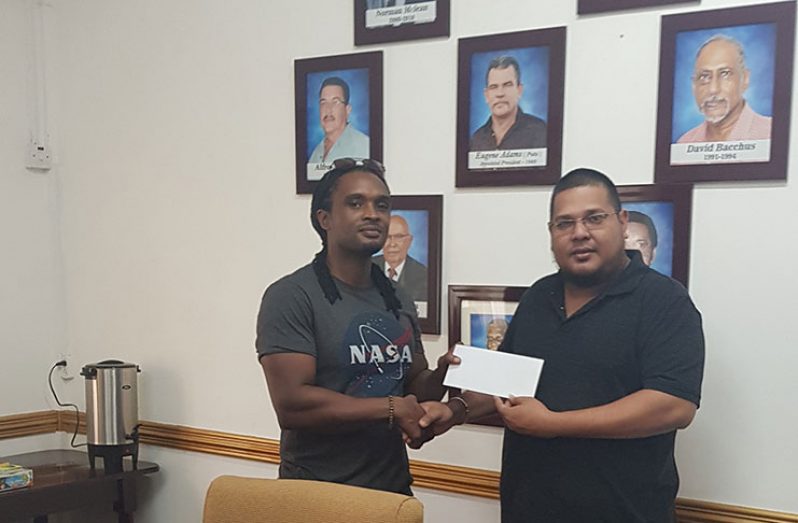 GGDMA’s Administrative Manager Avalon Jagnandan (Right) presents their contribution to GFF’s Coordinator Andrew Small.