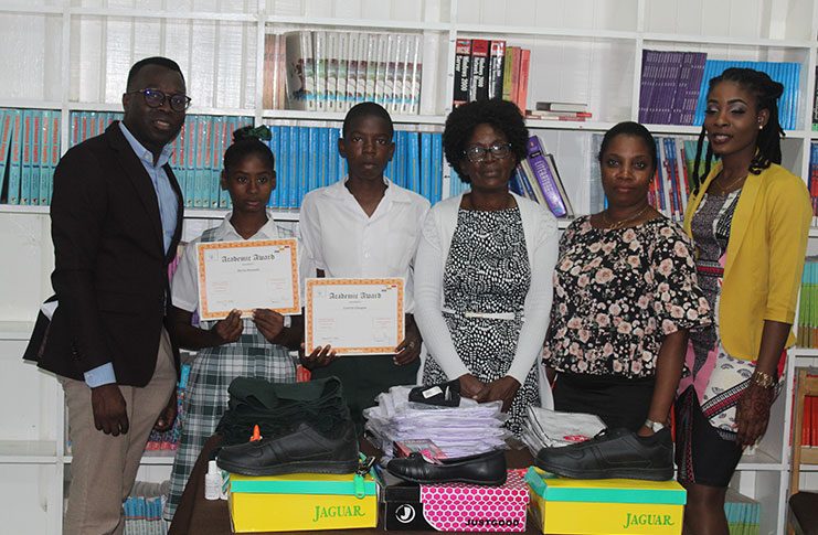 From left, Gavin Alleyne, Sierra Samuels Curwin Glasgow with Deputy Head Teacher Donna Zammett, teachers Tracey Kingston, Yumanda Bobb and Mashaka Scott.