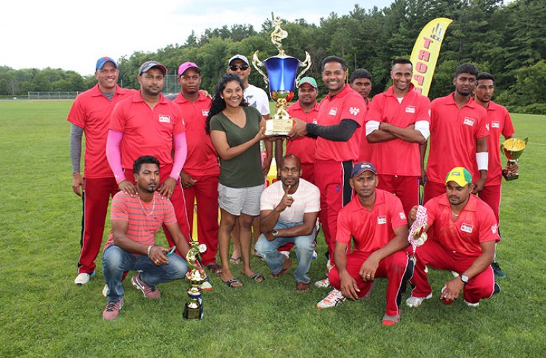 Flashback! SVC Mafia captain Anil Beharry collects the winning Open trophy from Emma Sunich, daughter of Ramesh Sunich, proprietor of Trophy Stall after his team won the category in the Toronto Cup Masters Softball cricket tournament earlier in the month.