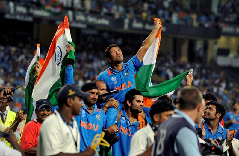 India's Sachin Tendulkar is carried by his team mates  for a victory lap after they beat Sri Lanka in the ICC Cricket World Cup final match in Mumbai April 2, 2011. REUTERS/Philip Brown/File Photo