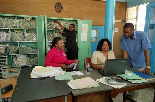 Some records department employees who will benefit from the 15% increase