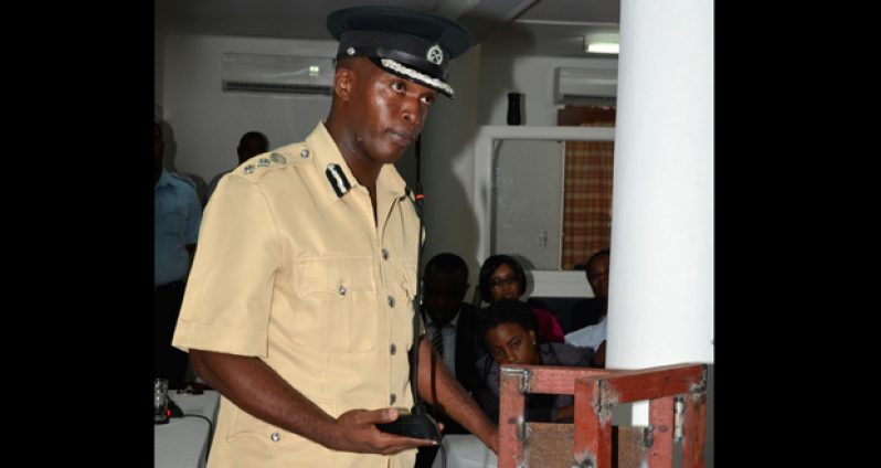 Deputy Director of Prisons, Gladwin Samuels, demonstrating to the Commission how easy it is to open the door of any division under normal conditions