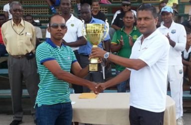 Congrats Cheesy! Captain of the victorious Demerara senior Inter-county team Vishaul ‘Cheesy’ Singh proudly uplifts the winners’ trophy and cheque from GCB secretary Anand Sanasie (right), while in background from left: Grantley Culbard, Rayon Griffith, Colin Stuart, Nazimul Drepaul and Shivnarine Chanderpaul share the moment.