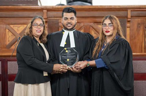 General Secretary (GS) of the Sanatan Dharma Maha Sabha (SDMS), Sabita Lalu (left) and member of the SDMS, attorney-at-law, Ms. Geeta Chandan-Edmond (at right), with SDMS member, Rodley Meren Mathoo (centre) who had received an award for recently being admitted to the bar (Delano Williams photo)