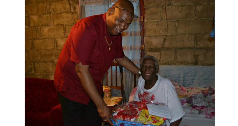 Another happy senior citizen of Sophia receiving her hamper Tuesday from Minister  Edghill