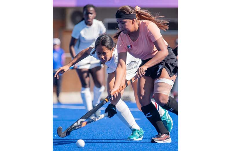 Guyana captain Sarah Klautky battling for the ball against Mexico