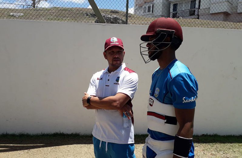 Ramnaresh Sarwan interacts with one of the Windies batsmen at the camp. (CWI photo)
