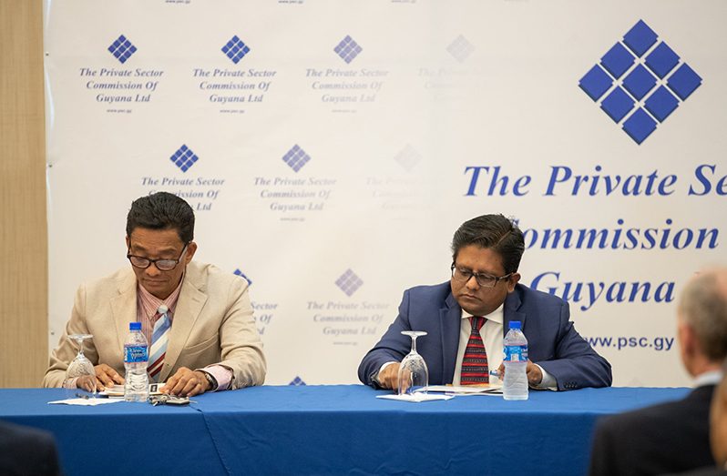 Senior Minister, Dr. Ashni Singh (right) and Chairman of the Private Sector Commission, Paul Cheong (left)