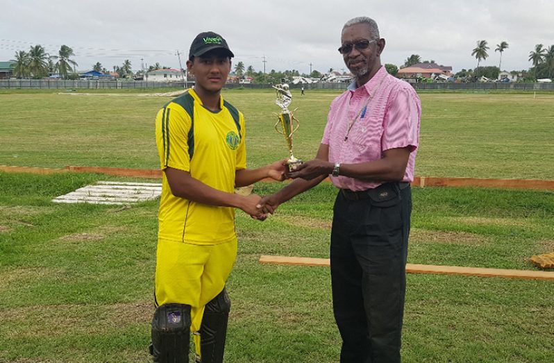 Kemol Savory collects the Man-of-the-Match trophy from match referee  Grantley Culbard, for his well-played 101.