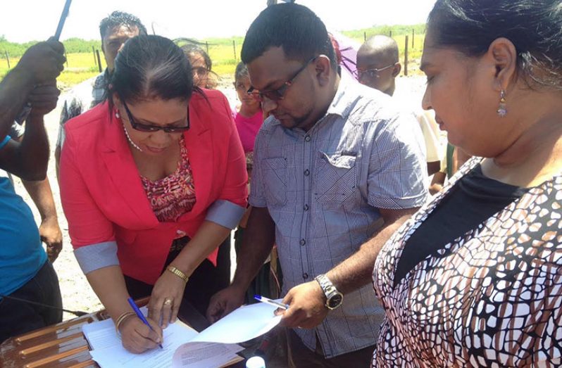 Regional Executive Officer of Region Six, Kim Stephens, signs the contract for construction of the school in the presence of Regional Engineer Roopesh Persaud and Regional Education Officer Valika Jaikishun. Also in photo are staffers of Number 36 nursery and primary schools