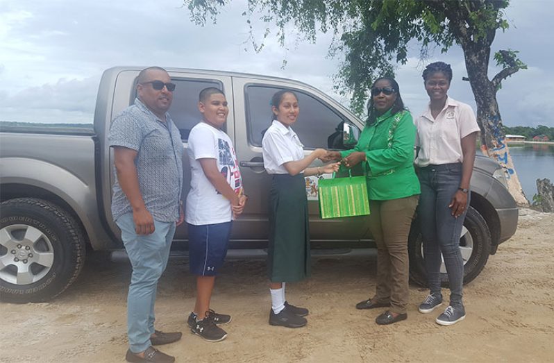 Minister within the Ministry of Agriculture, Valarie Adams-Yearwood presenting national CSEC top student, Riana Toney, with a gift in recognition of her outstanding academic performance