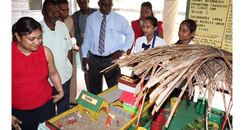 Students explain their science projects on sustainable farming to Minister of Education, Ms Priya Manickchand (left), and Education Officers at the National Science Fair 2014