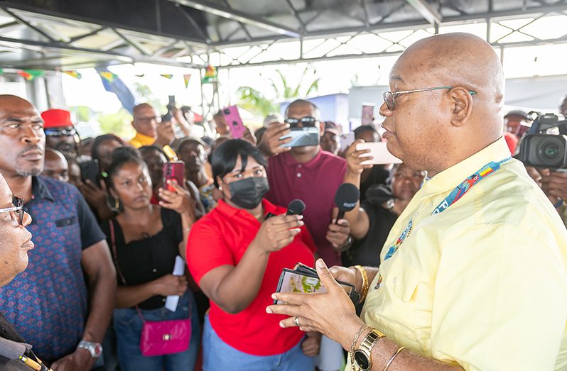 The Minister of Public Works, Bishop Juan Edghill, speaking with vendors at the Kitty Seawall (Delano Williams photo)