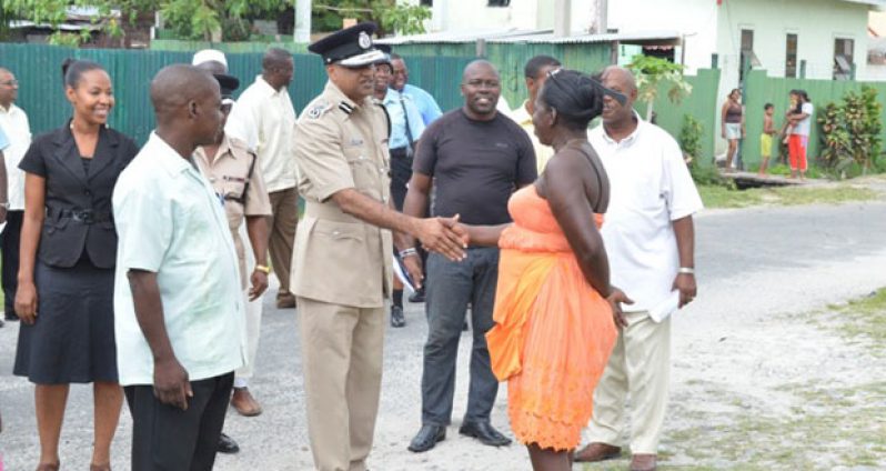 Commissioner of Police (Ag) Seelall Persaud, greeting a member of the Albouystown Community at the launch of the Albouystown Impact Project which was held at Independence Boulevard, Hunter Street, Albouystown