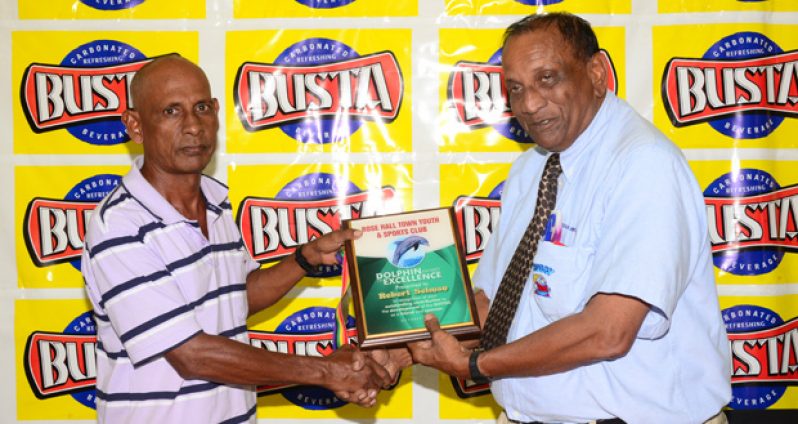 : Guyana Beverage Company’s Robert Selman receives his Dolphin Award of Excellence from Ravi Kissonlall