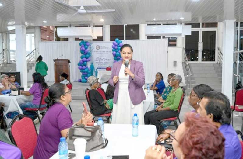 Minister of Human Services and Social Security, Dr Vindhya Persaud, chats with a group of senior folk
