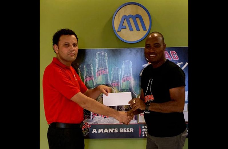 Pepsi Hornets treasurer Roger Perreira (left) receives the sponsor’s cheque from STAG Beer Brand Manager Nigel Worrell.