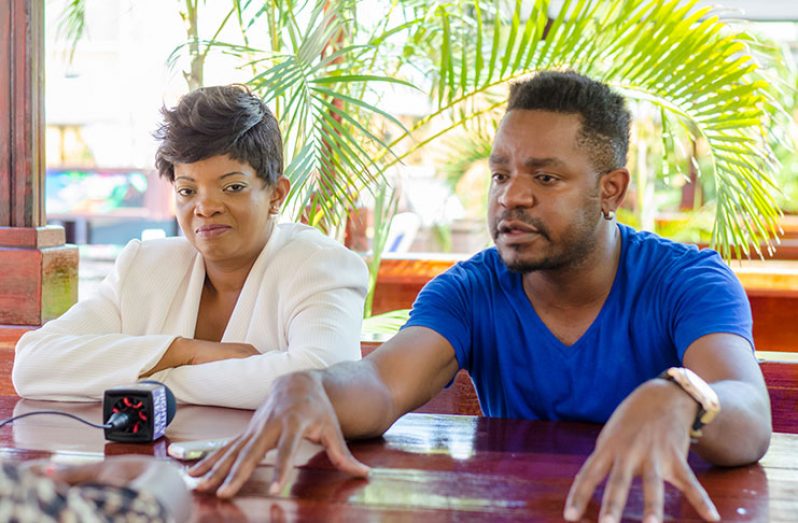 Co-Chair of the Caribbean Sex Workers Coalition, Marlon Taylor, stands alongside the Chair, Miriam Edwards