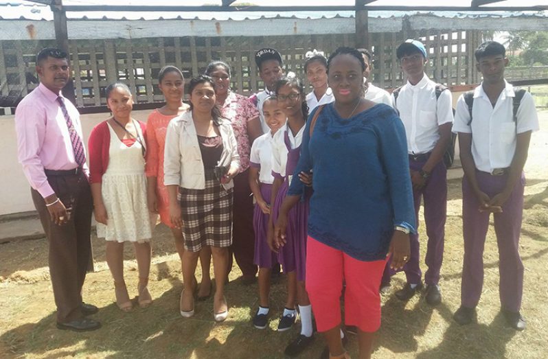 The headmaster Imran Ally, left, along with Andrea Charles, Christine Persaud, Ashley-Ann Fable, Tain lecturer Chelsey Halley-Crawford and students of the school.