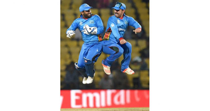 Mohammad Shahzad and Samiullah Shenwari celebrate Afghanistan's win over Zimbabwe in Nagpur yesterday.