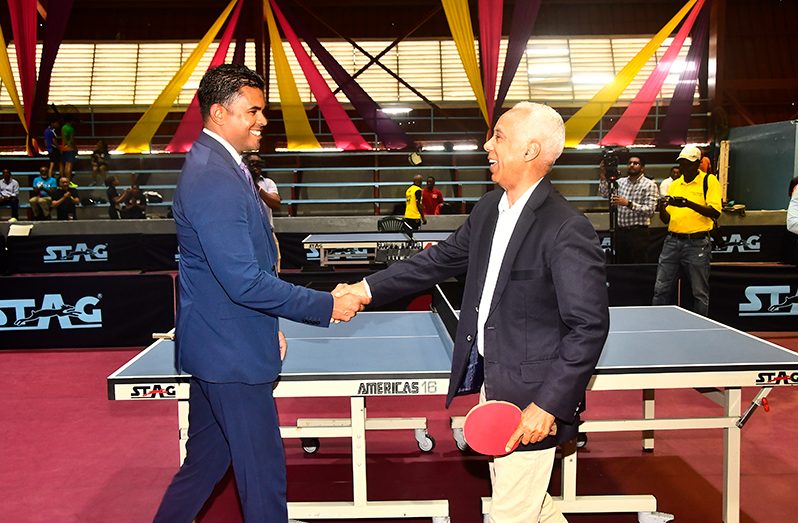 Caribbean Table Tennis Federation (CRTTF) president, Teddy Matthews (right) shakes hand with Minister of Sport, Charles Ramson Jr. (Adrian Narine photo)